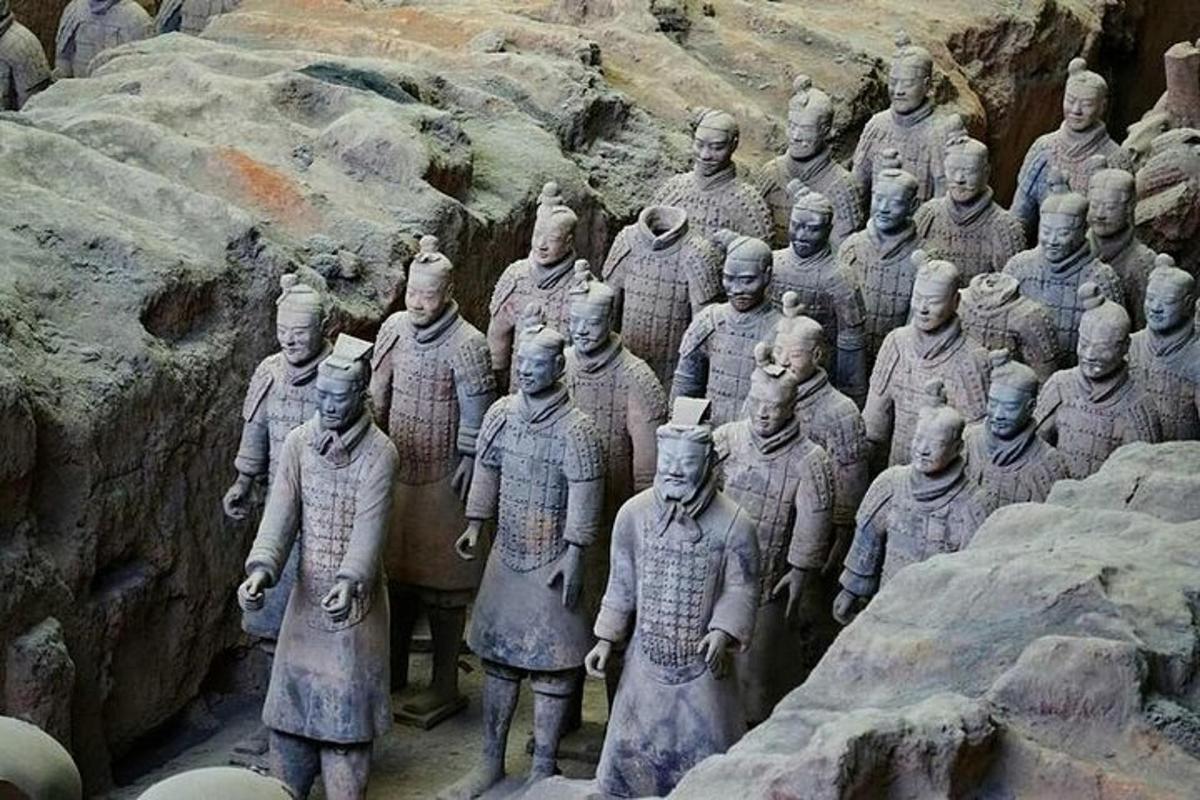 a group of statues of men standing on a mountain