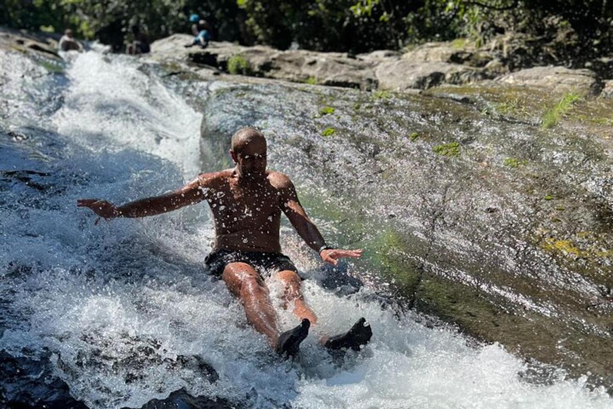 a man is in the water in a waterfall