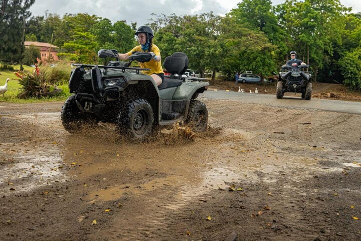 a man riding a four wheeler on a dirt road