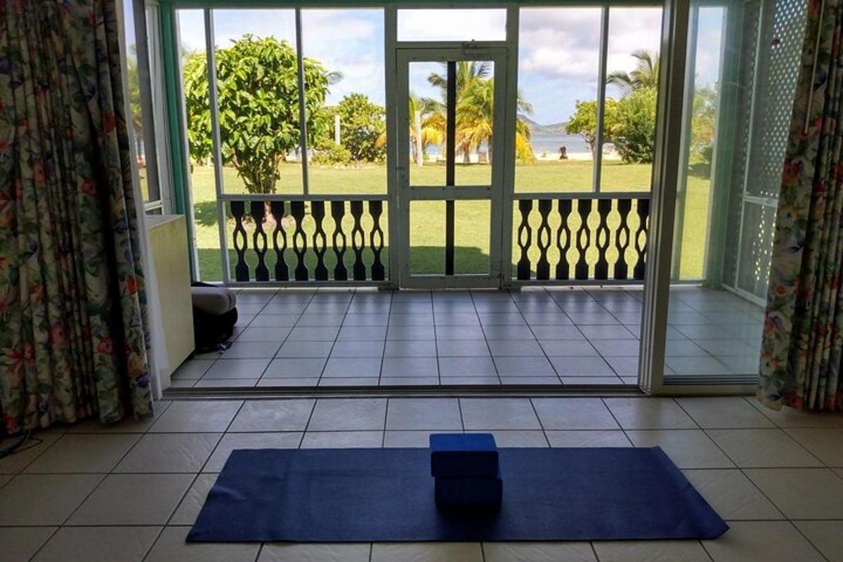 a blue yoga mat on the floor in front of a door