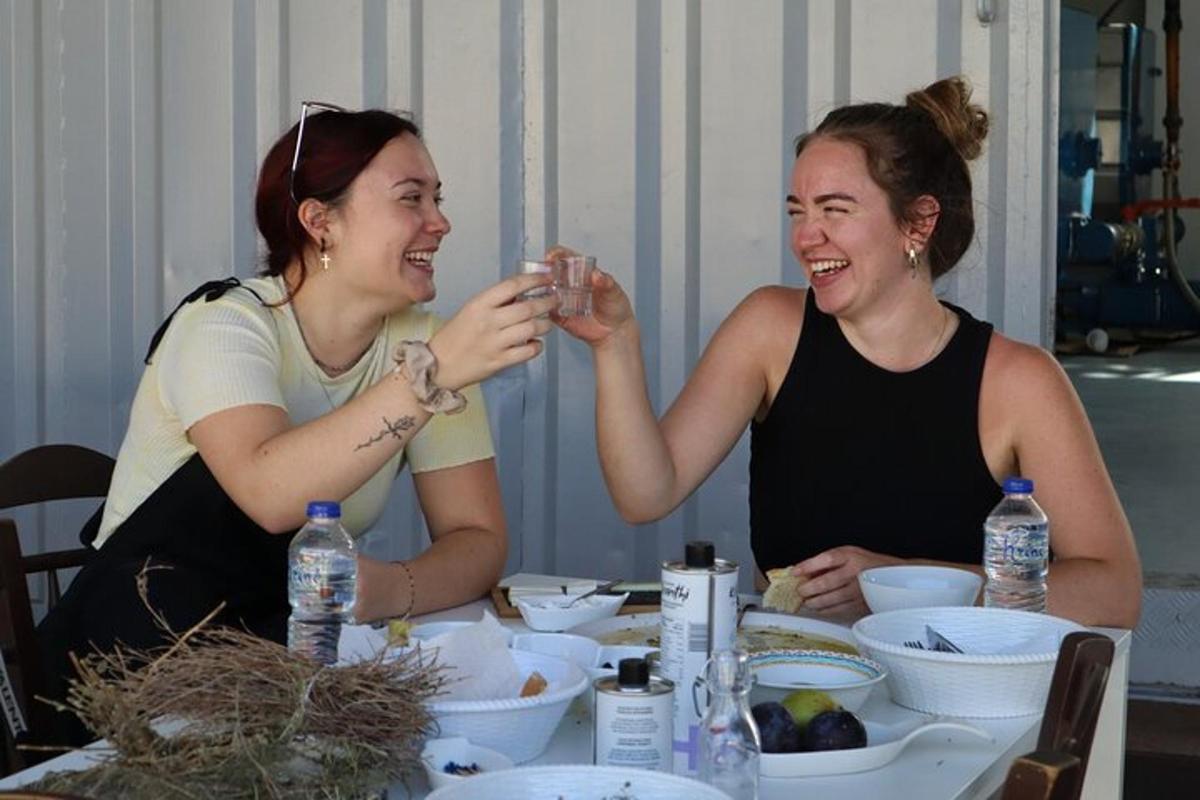 Dos mujeres sentadas en una mesa sonriendo y riendo