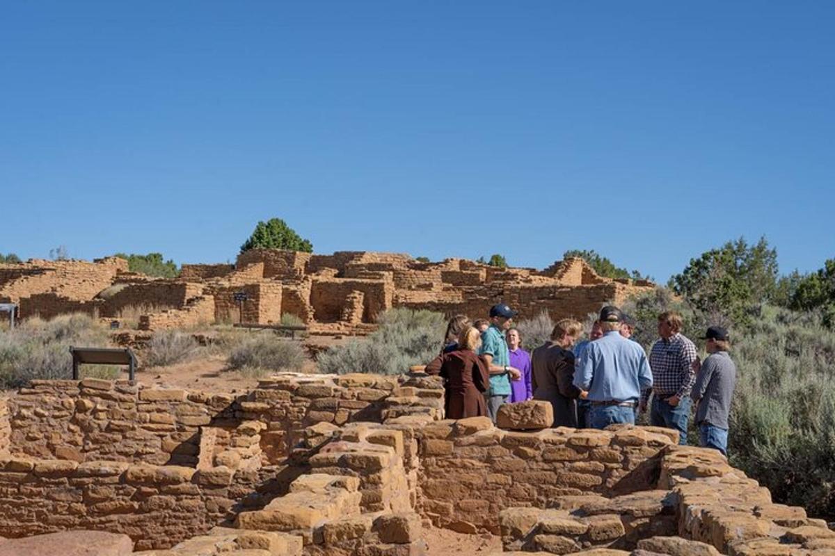 a group of people standing on top of a stone wall