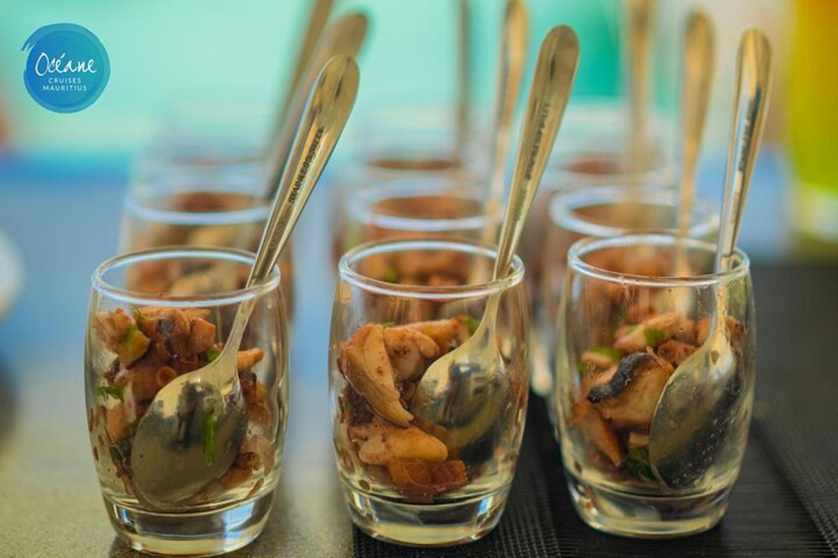 four glasses with food in them on a table