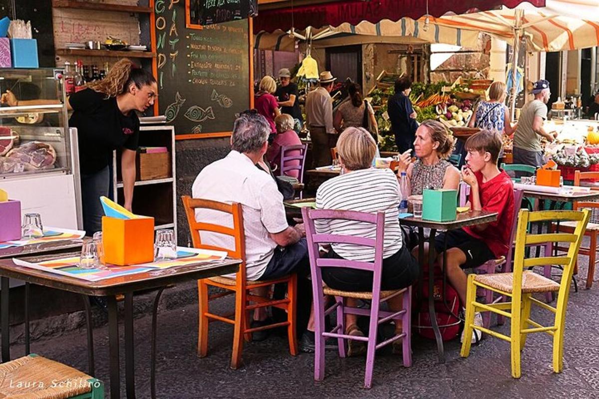 a group of people sitting at tables in a restaurant
