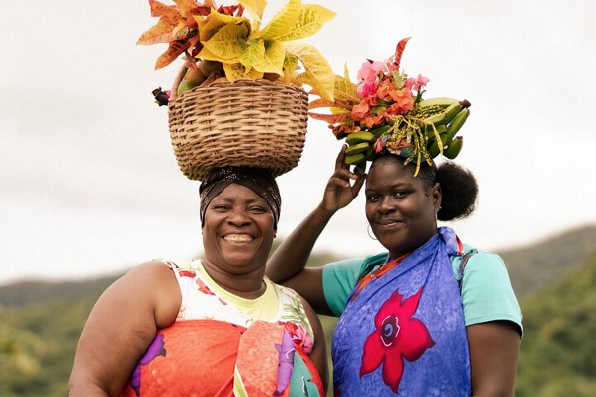 two women standing next to each other with a basket on their head