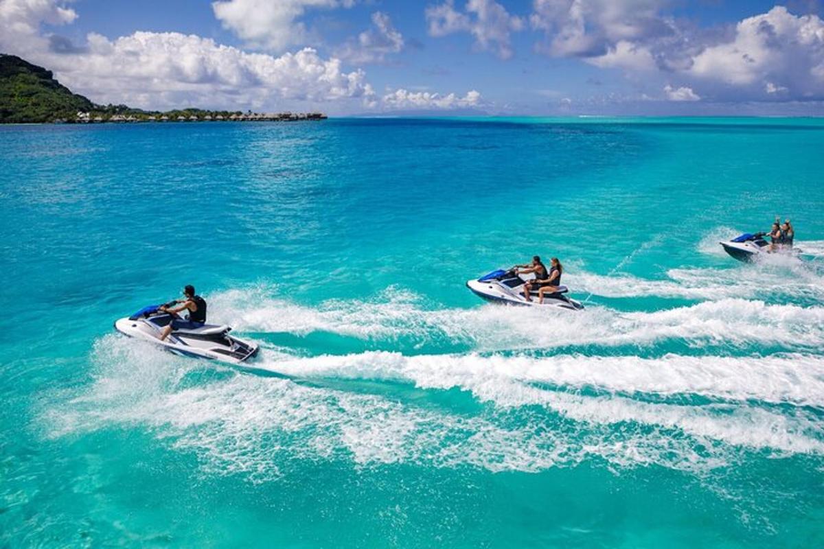 two people riding on jet skis in the water