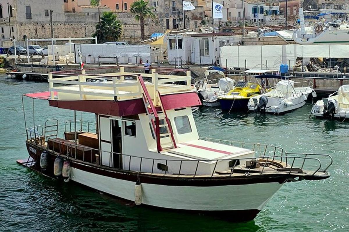 ένα σκάφος είναι αγκυροβολημένο σε ένα λιμάνι με άλλα σκάφη