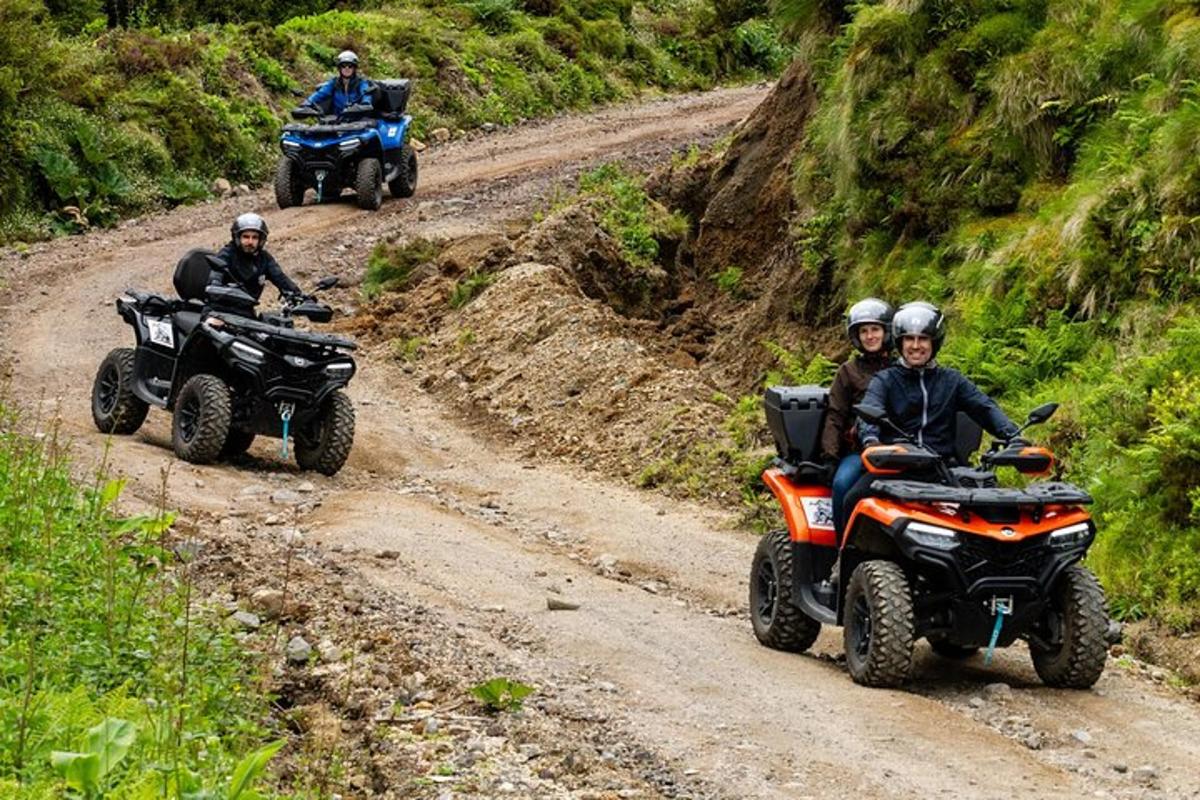 a group of people riding atvs on a dirt road