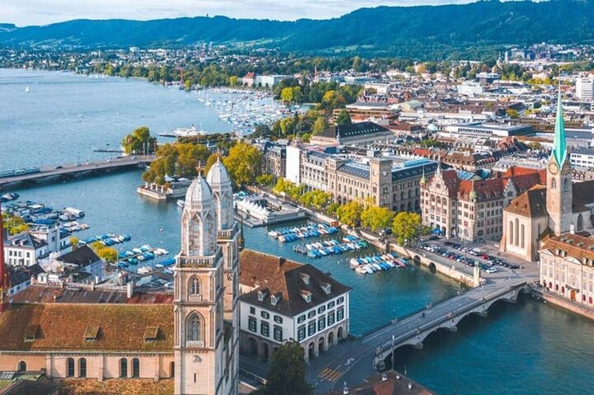 an aerial view of a city with a river and buildings