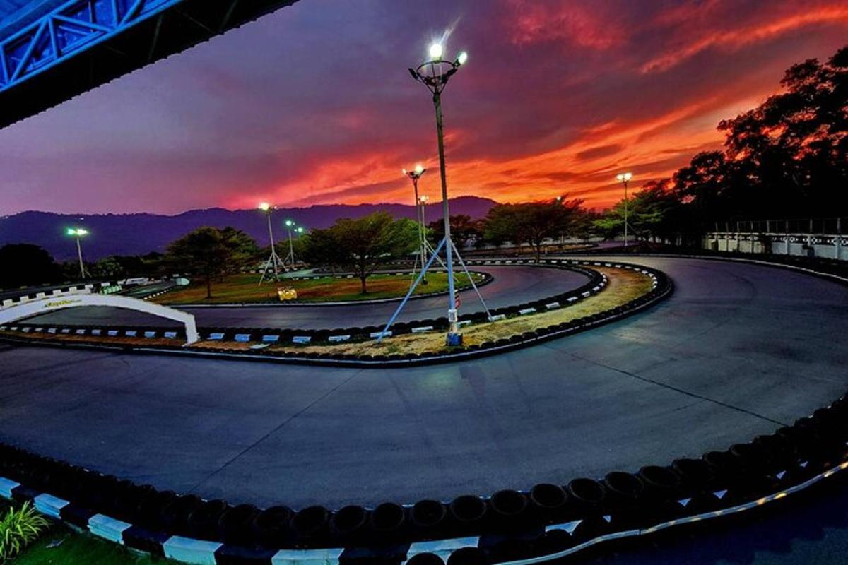 a winding road with a sunset in the background