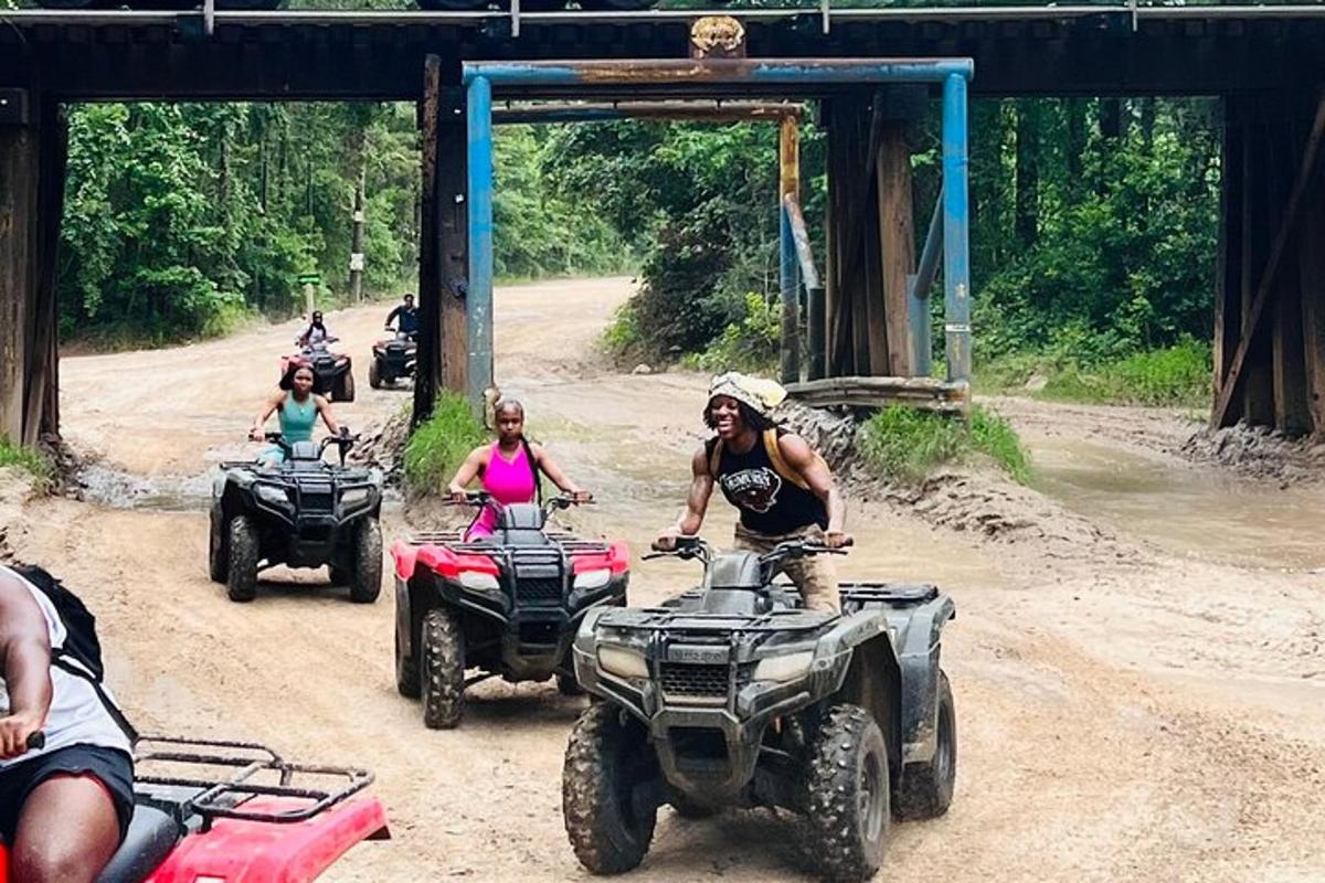 a group of people riding atvs on a dirt road