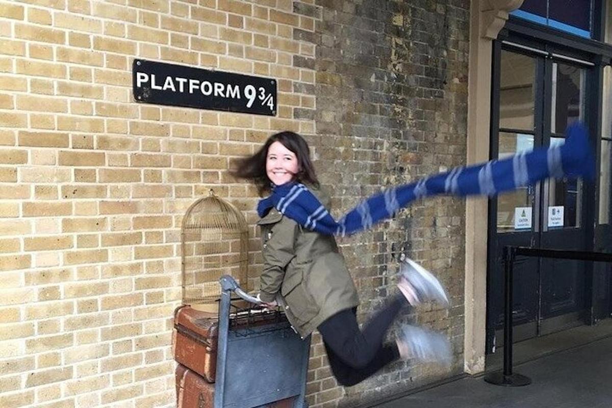 a woman is jumping off of a brick wall