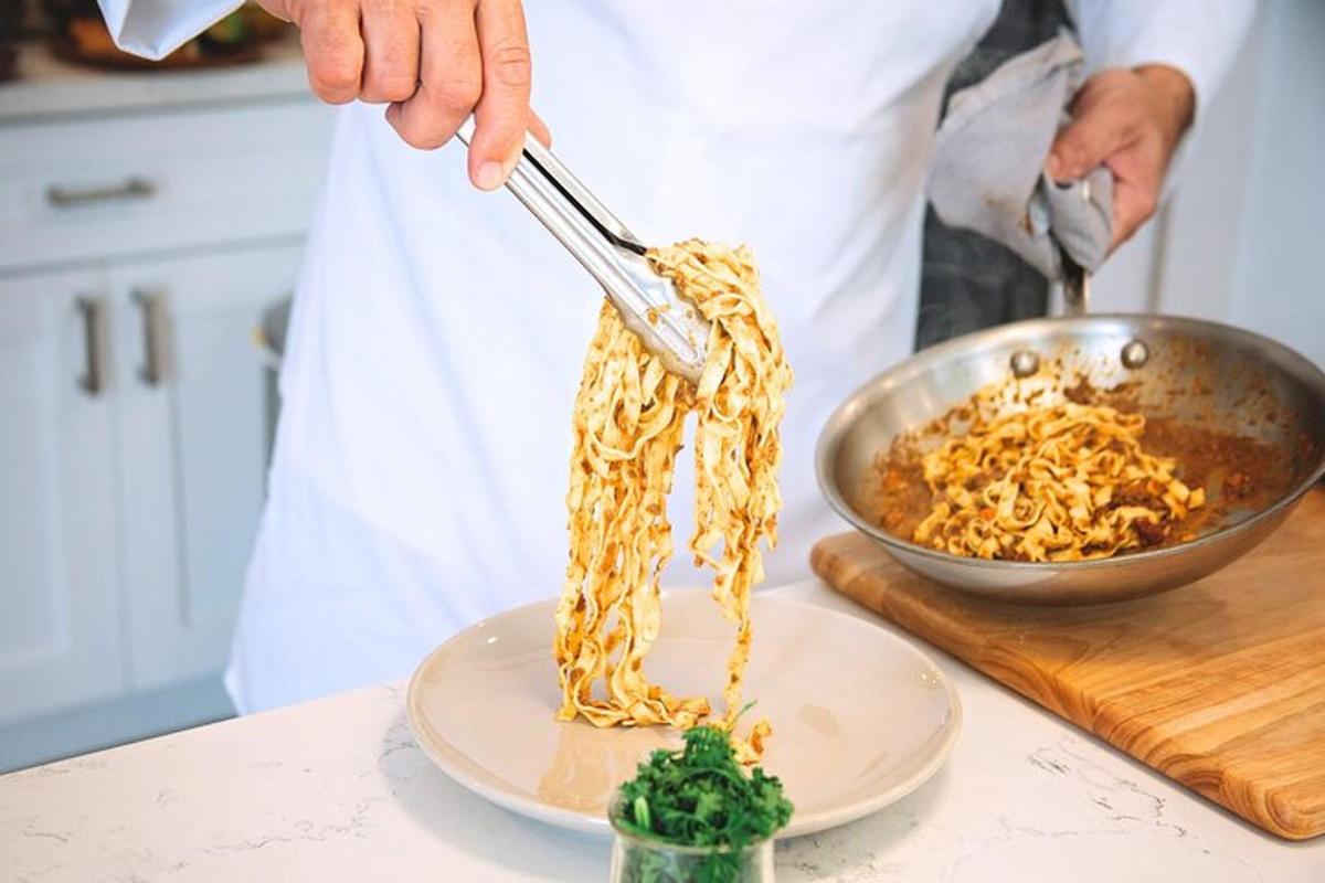 Maður er að útbúa pasta á diski