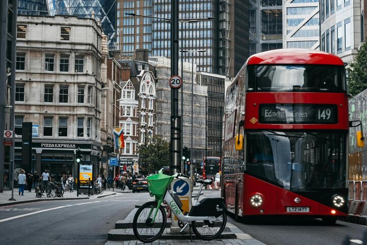 a red double decker bus driving down a city street