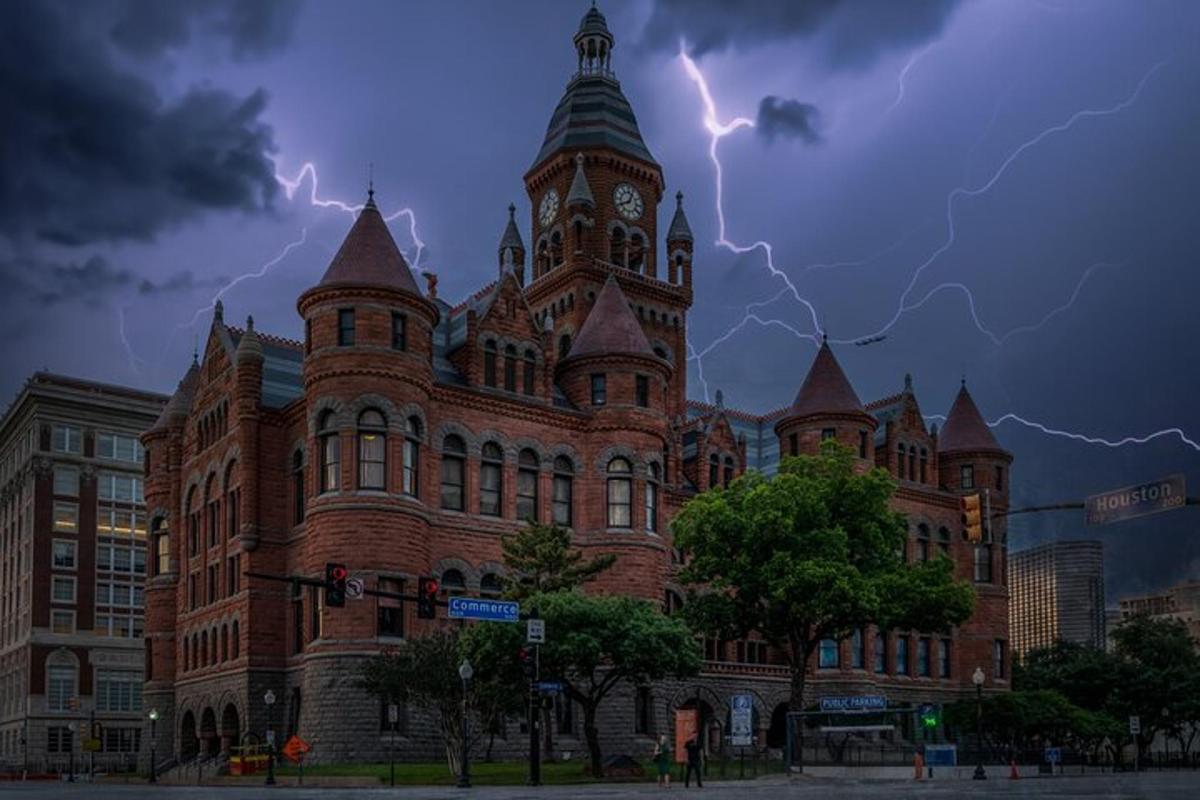 a large brick building with lightning bolts in the sky