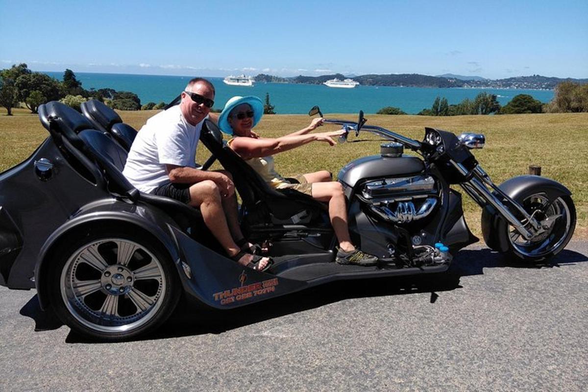 a man and woman sitting in a motorcycle side car