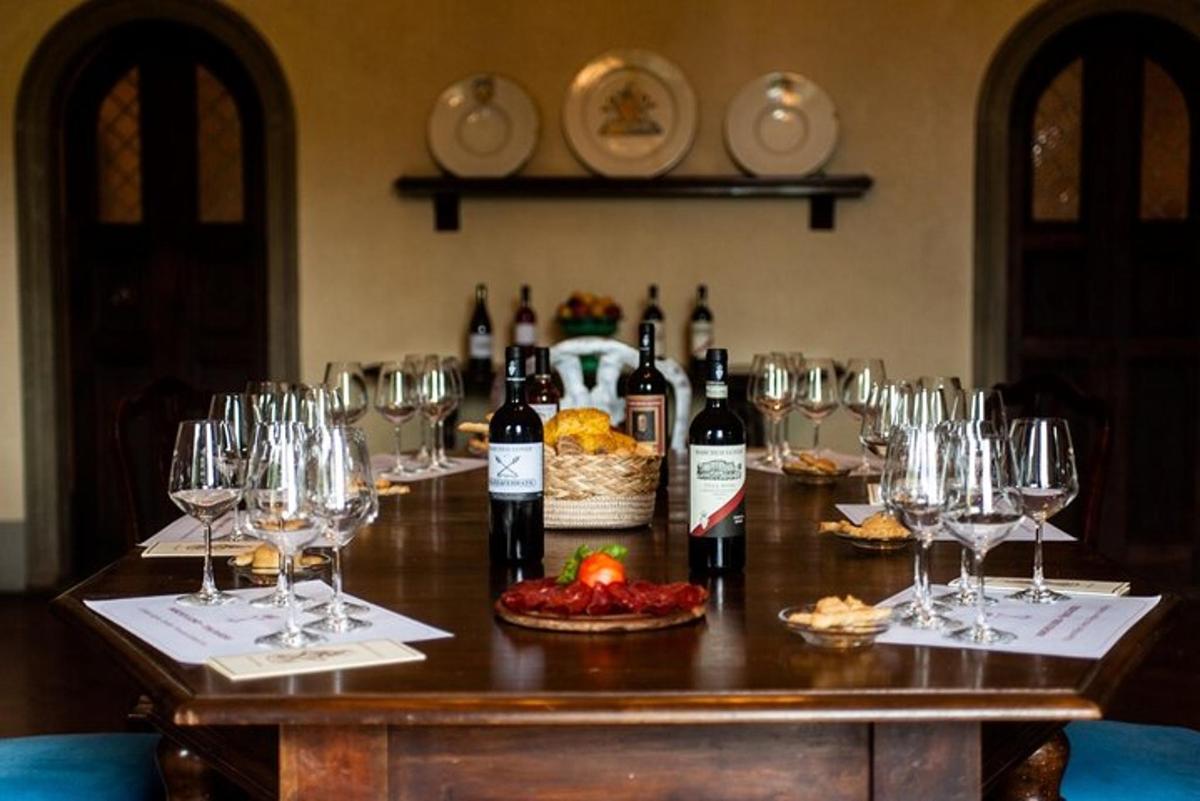 a table with wine bottles and wine glasses