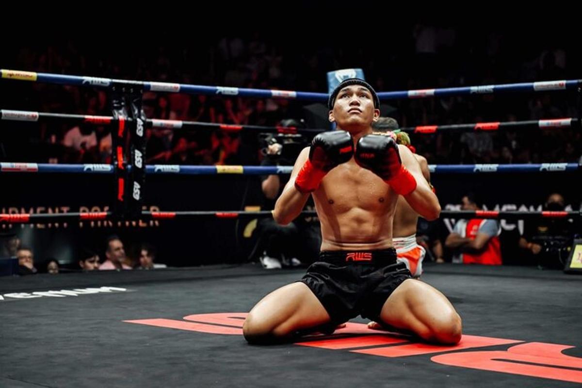 a man laying on the ground in a boxing ring