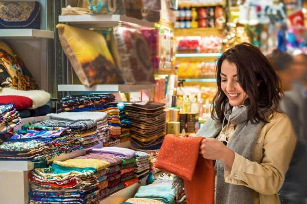 a woman standing in a store looking at fabrics