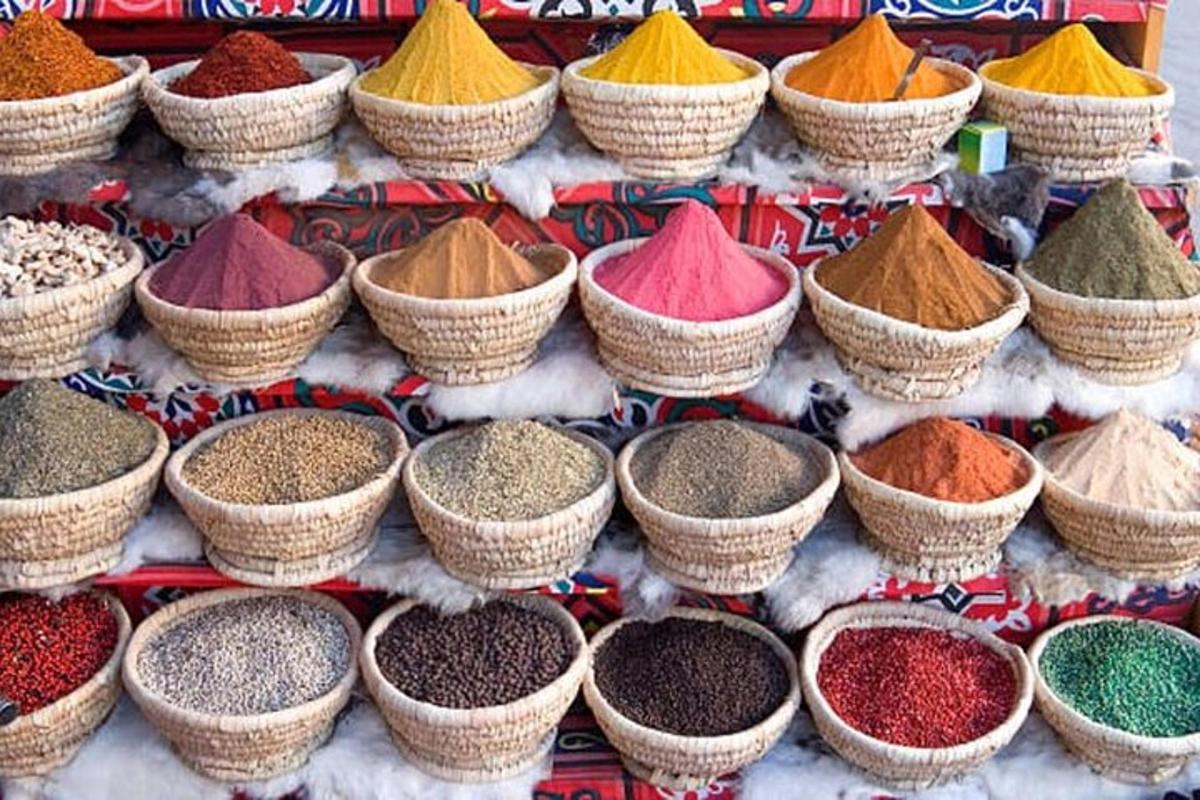 a group of baskets filled with different colored spices
