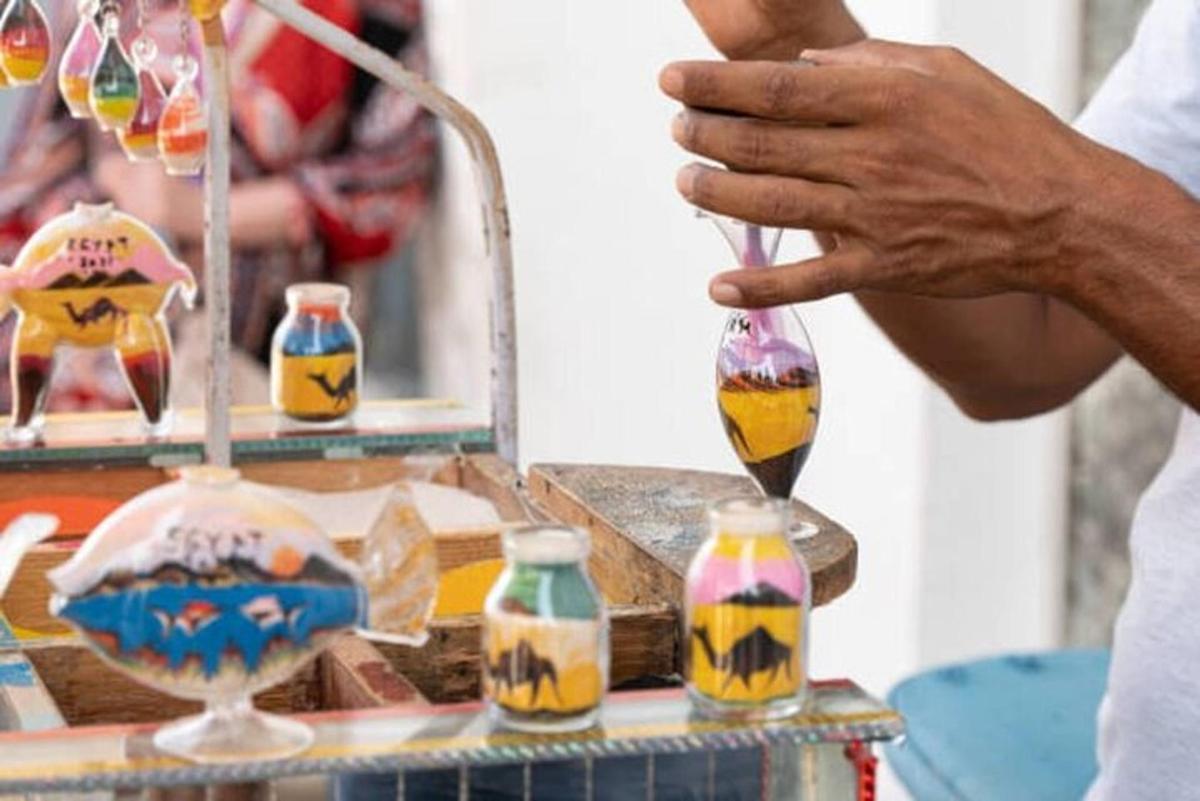 a person is holding a spoon in front of a table