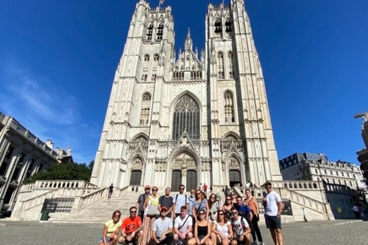 a group of people posing in front of a cathedral