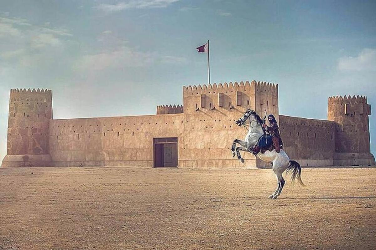 a person riding a horse in front of a castle