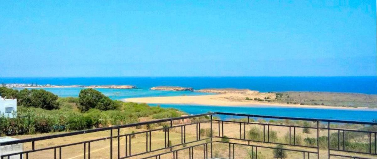 a view of a beach with the ocean in the background