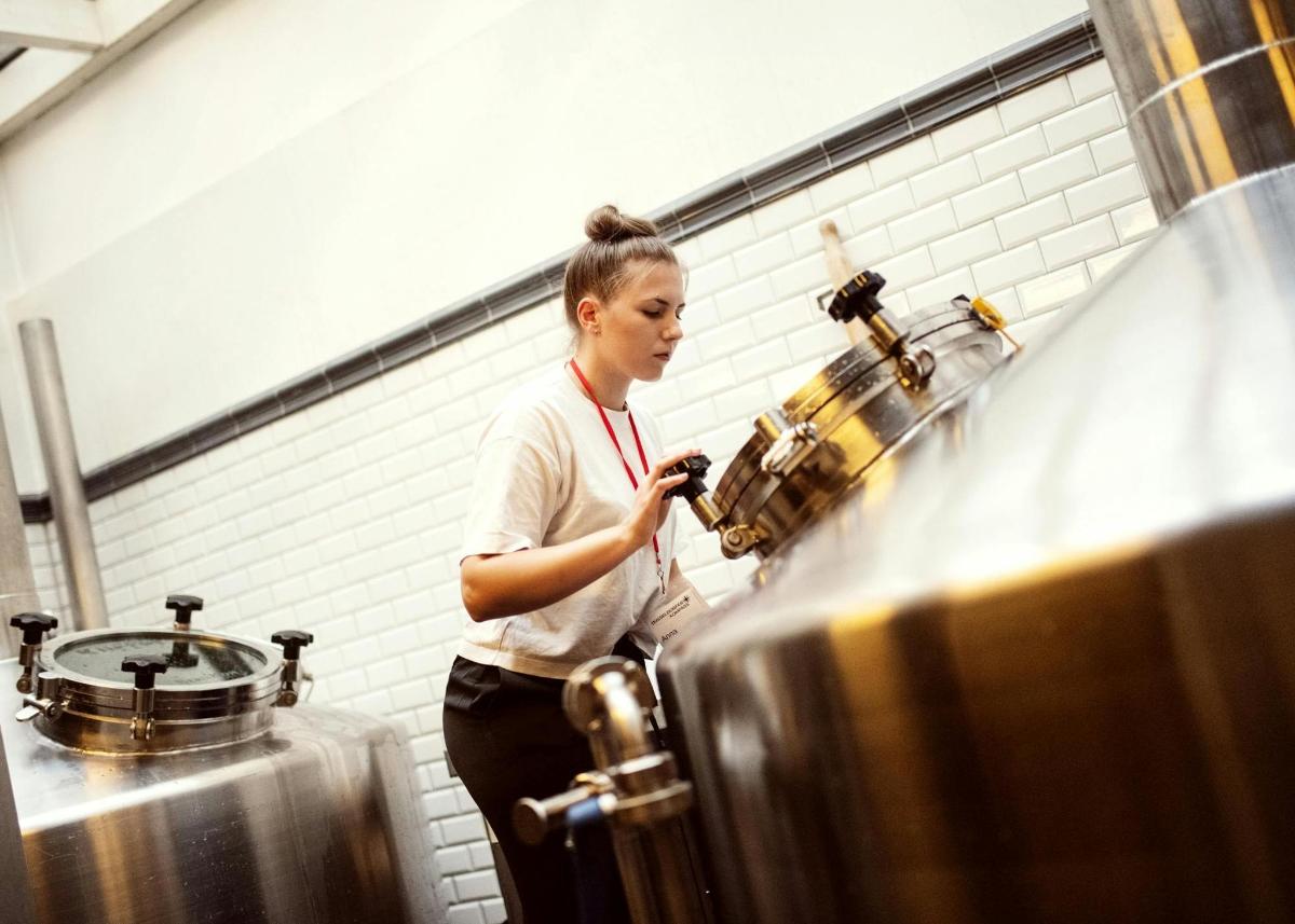 a woman standing in a kitchen preparing food