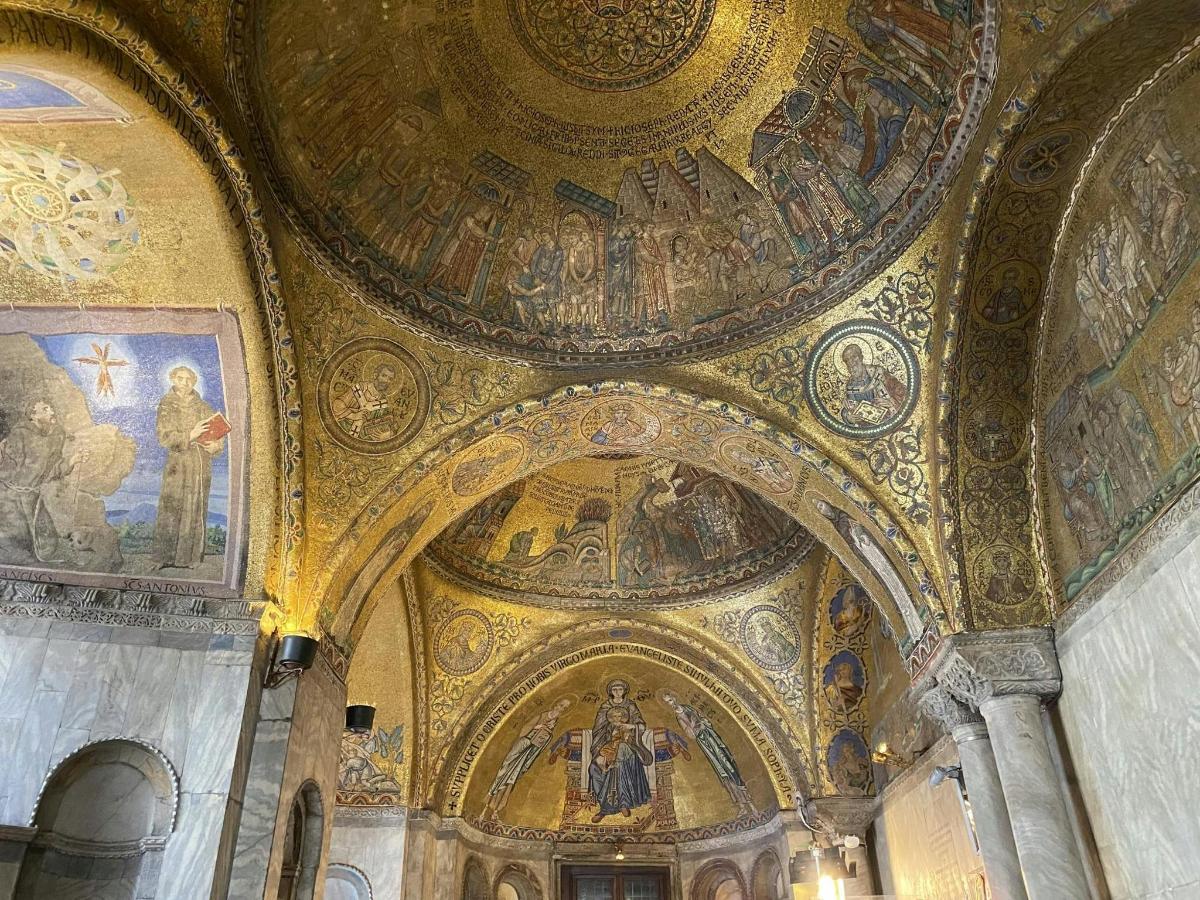 una chiesa con il soffitto ricoperto di mosaici e dipinti