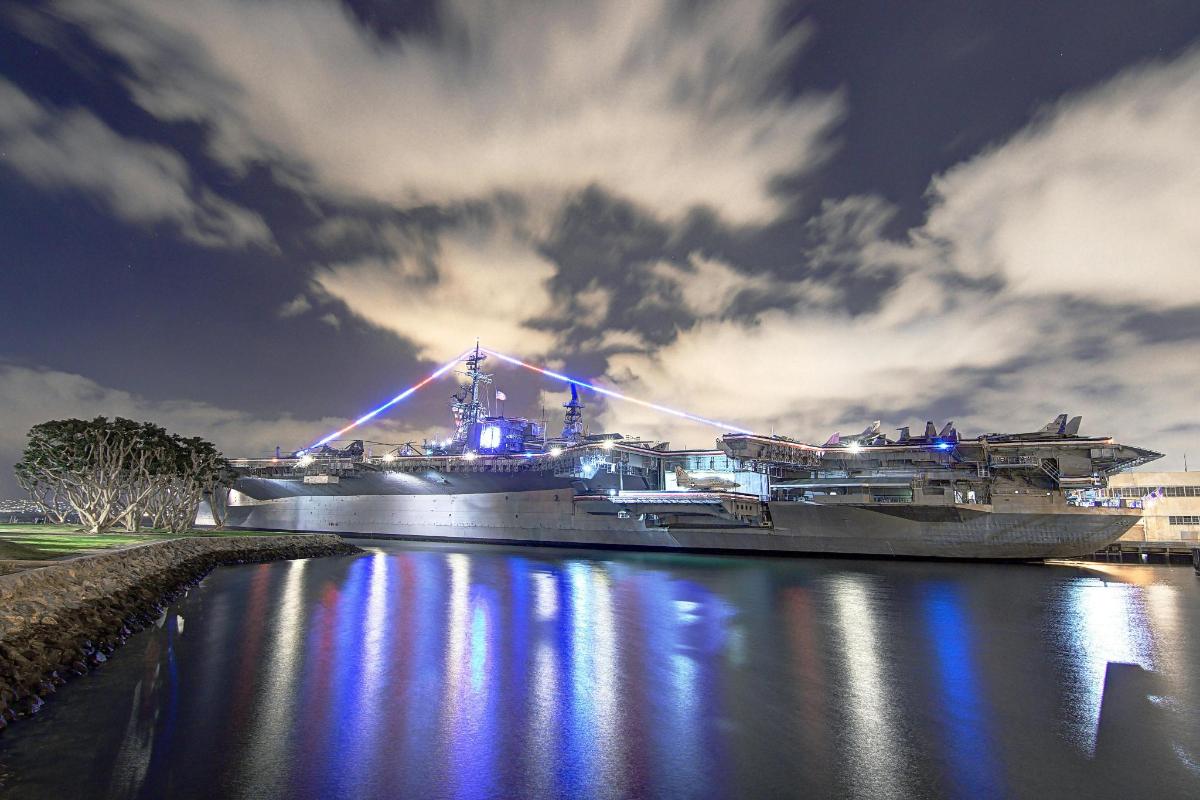 a large ship docked in a river at night