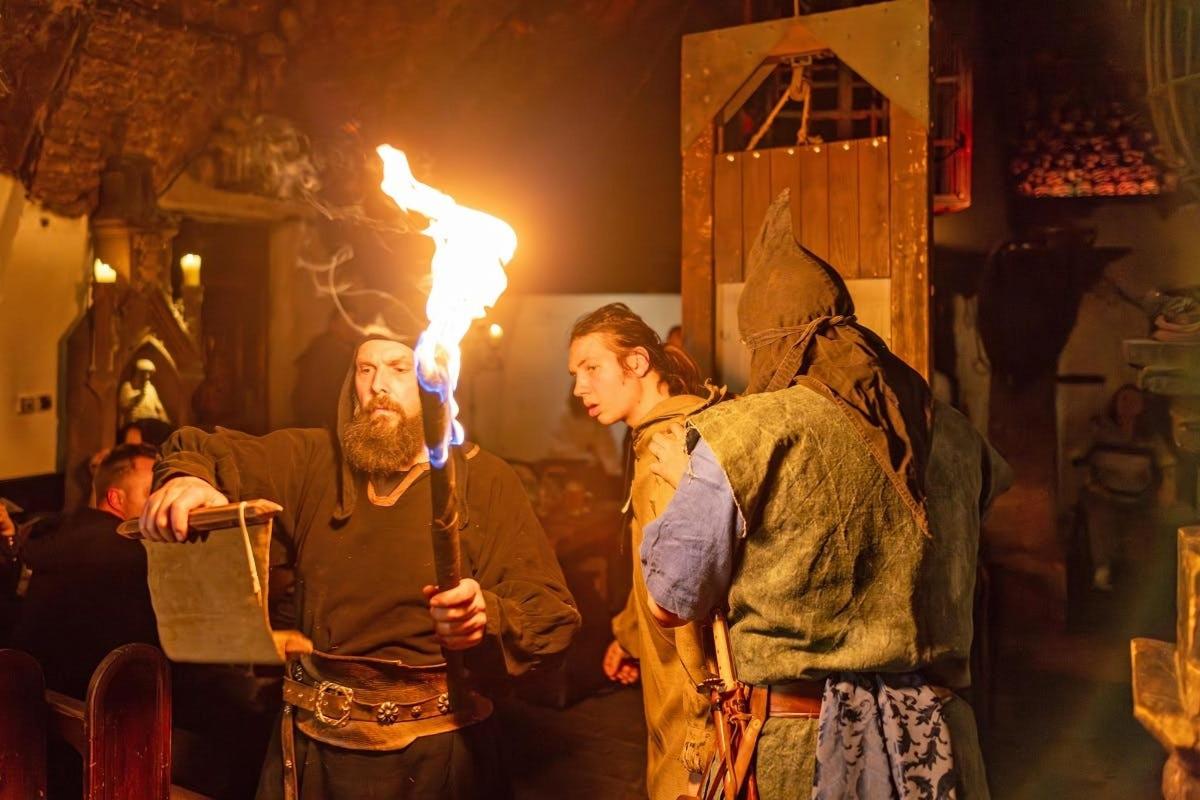 a man and a woman with a torch in a performance