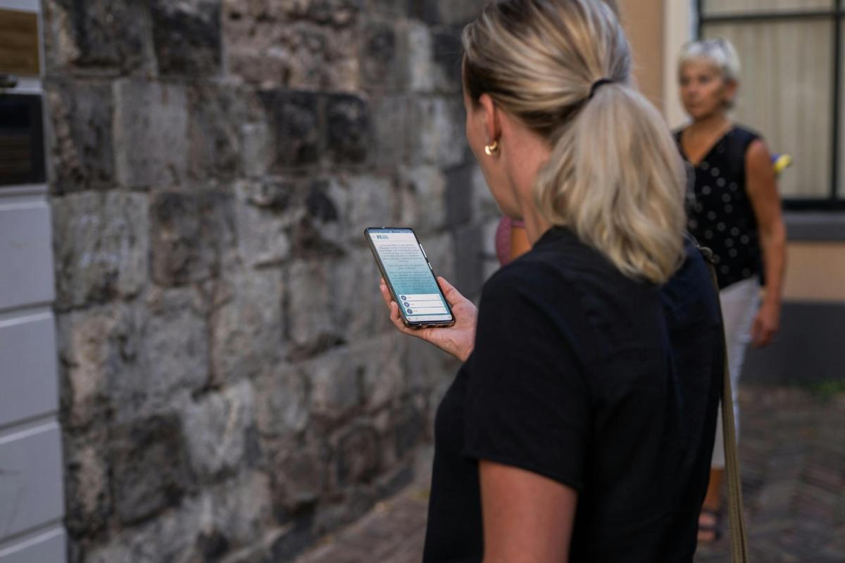 a woman holding a cell phone in her hand