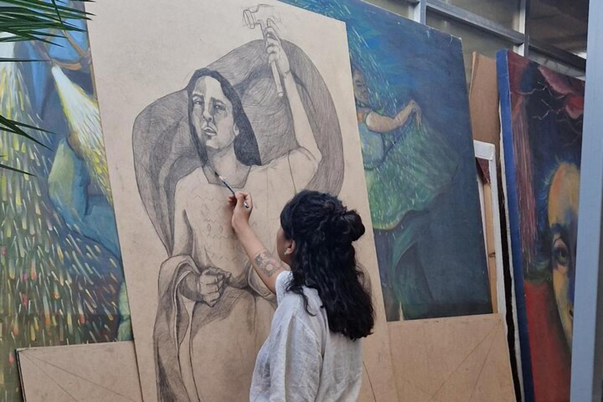 a woman painting a mural on a wall