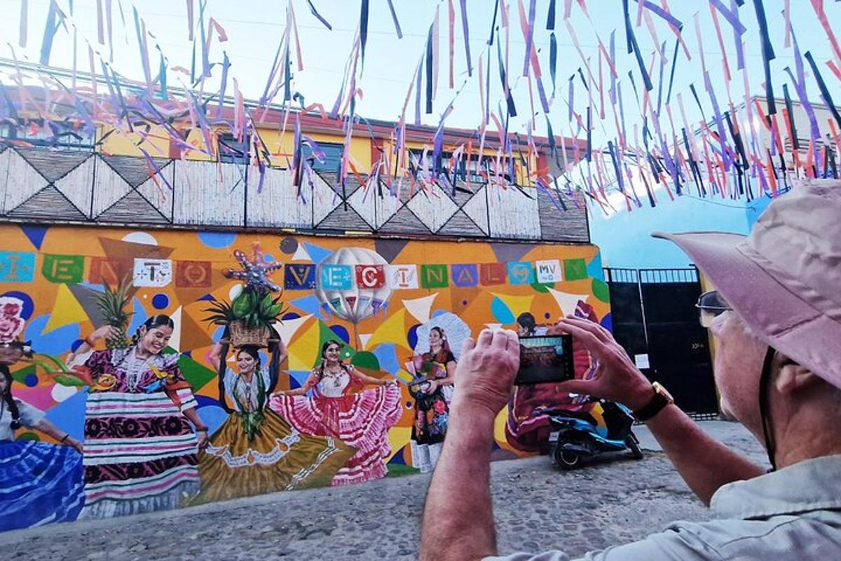 a man taking a picture of a mural with a camera
