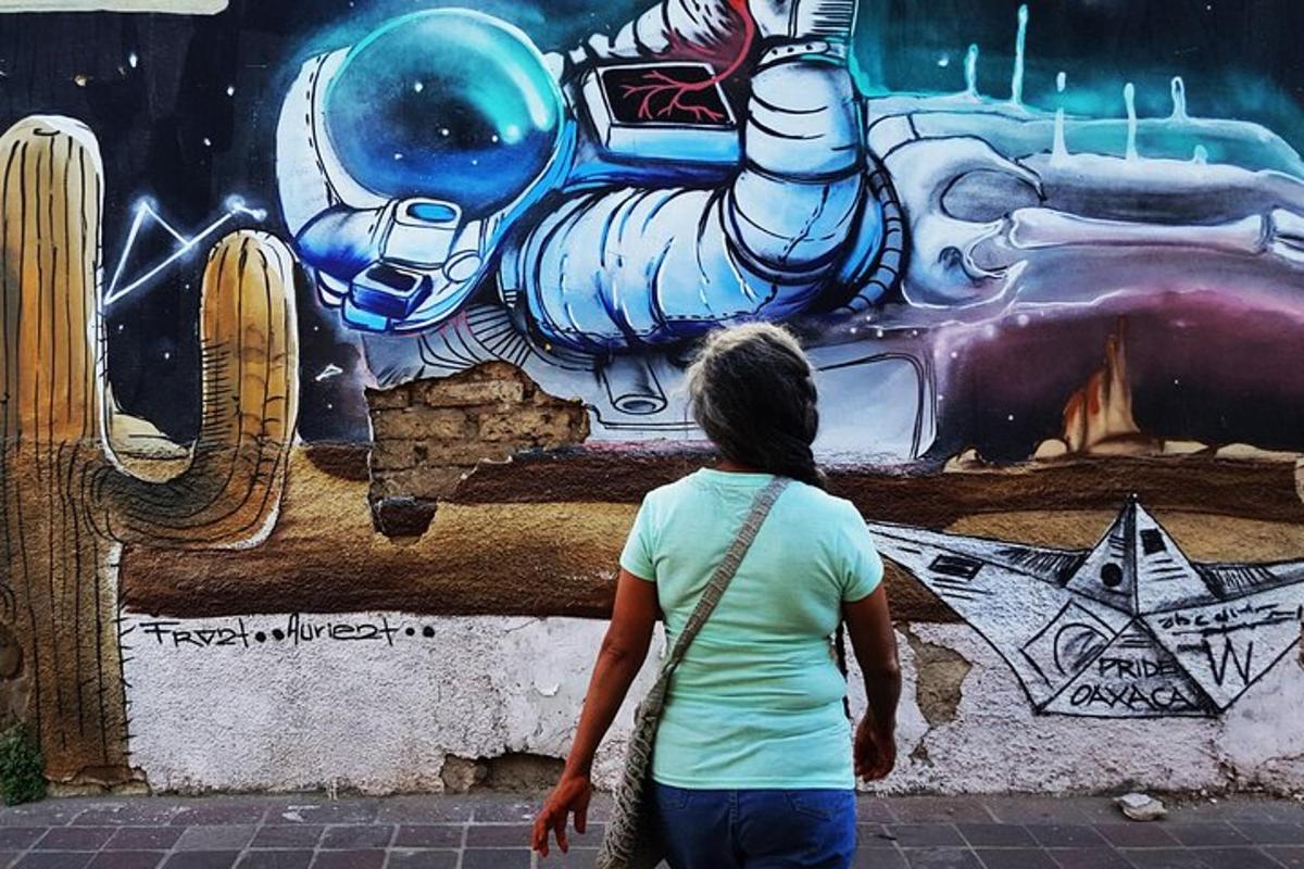 a woman walking past a wall with a mural
