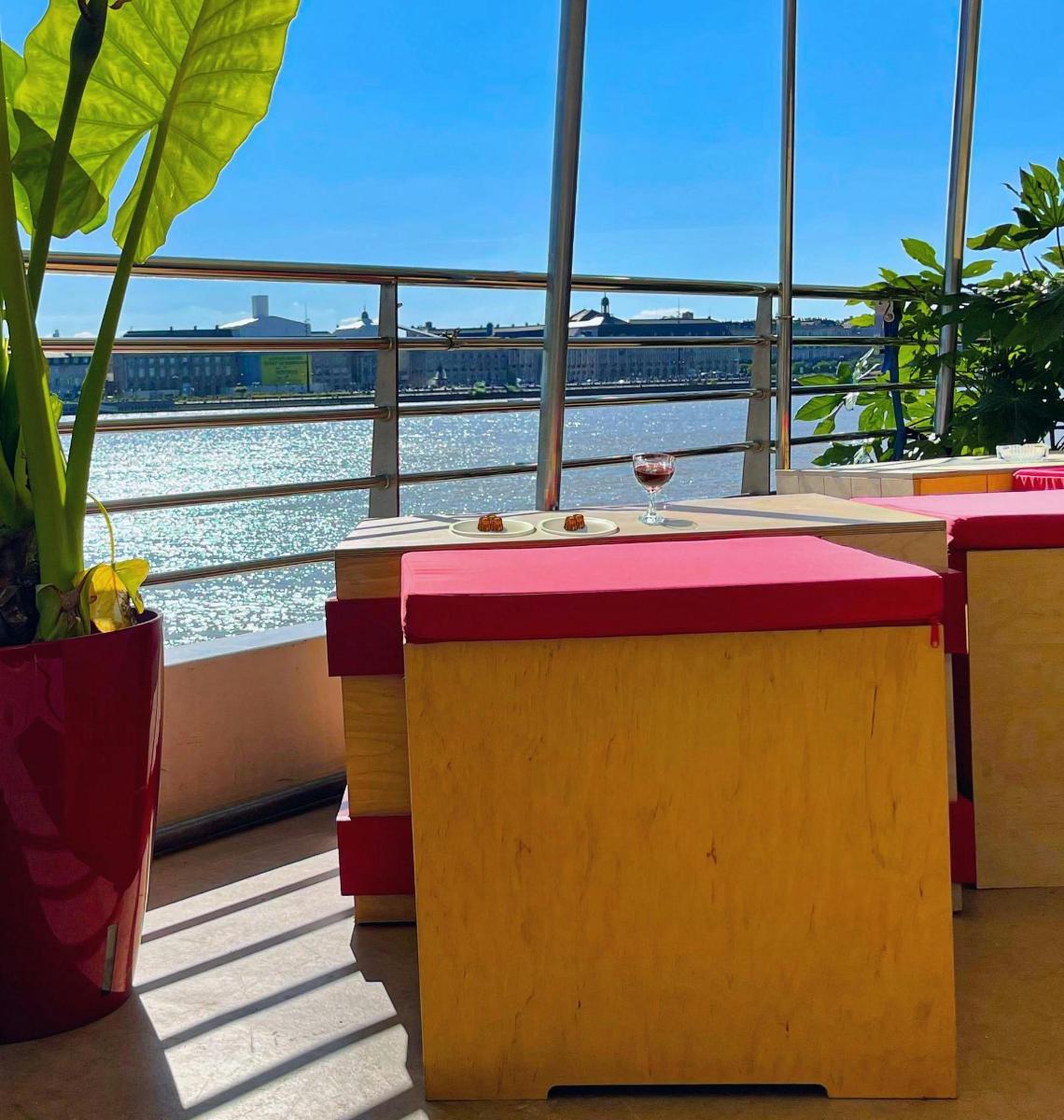 a table with a glass of wine next to a window