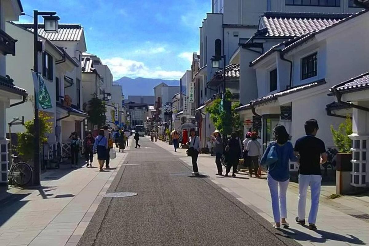 a group of people walking down a city street