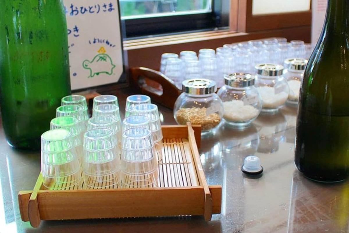 a table with a bunch of glasses and bowls of food