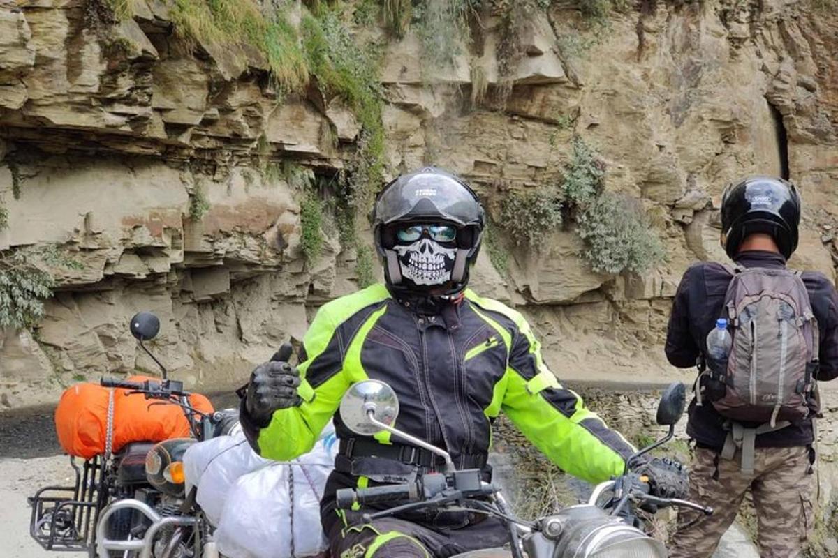 a man on a motorcycle with a skeleton mask on