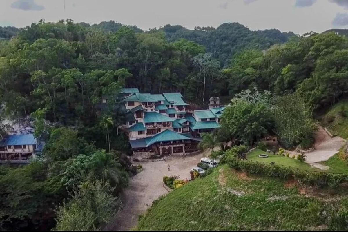 an aerial view of a resort with blue roofs