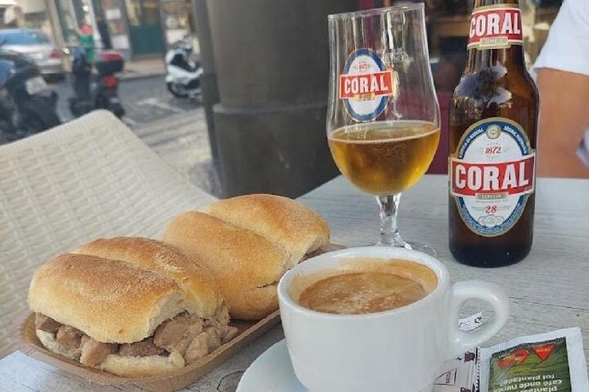 a sandwich and a cup of coffee and a glass of beer
