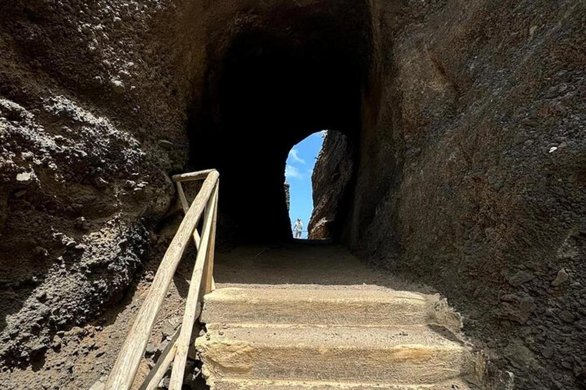 a tunnel with stairs leading into a cave