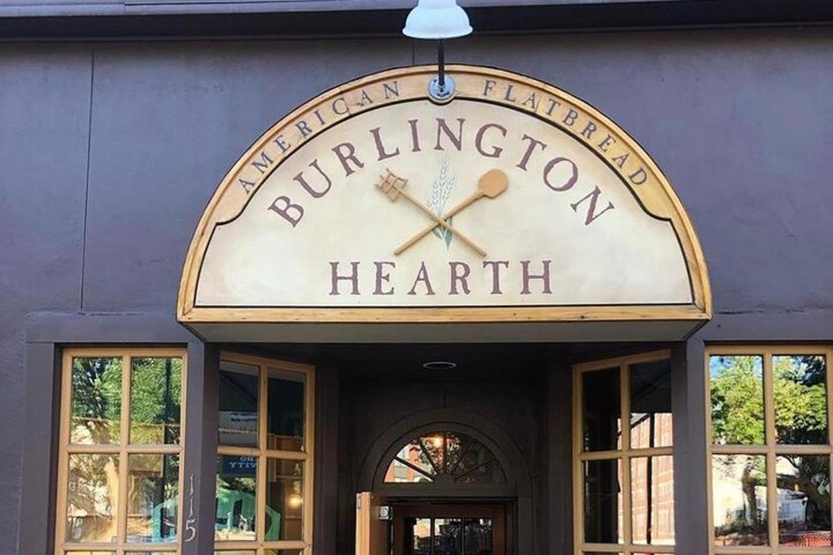 a sign on the front of a building with a clock