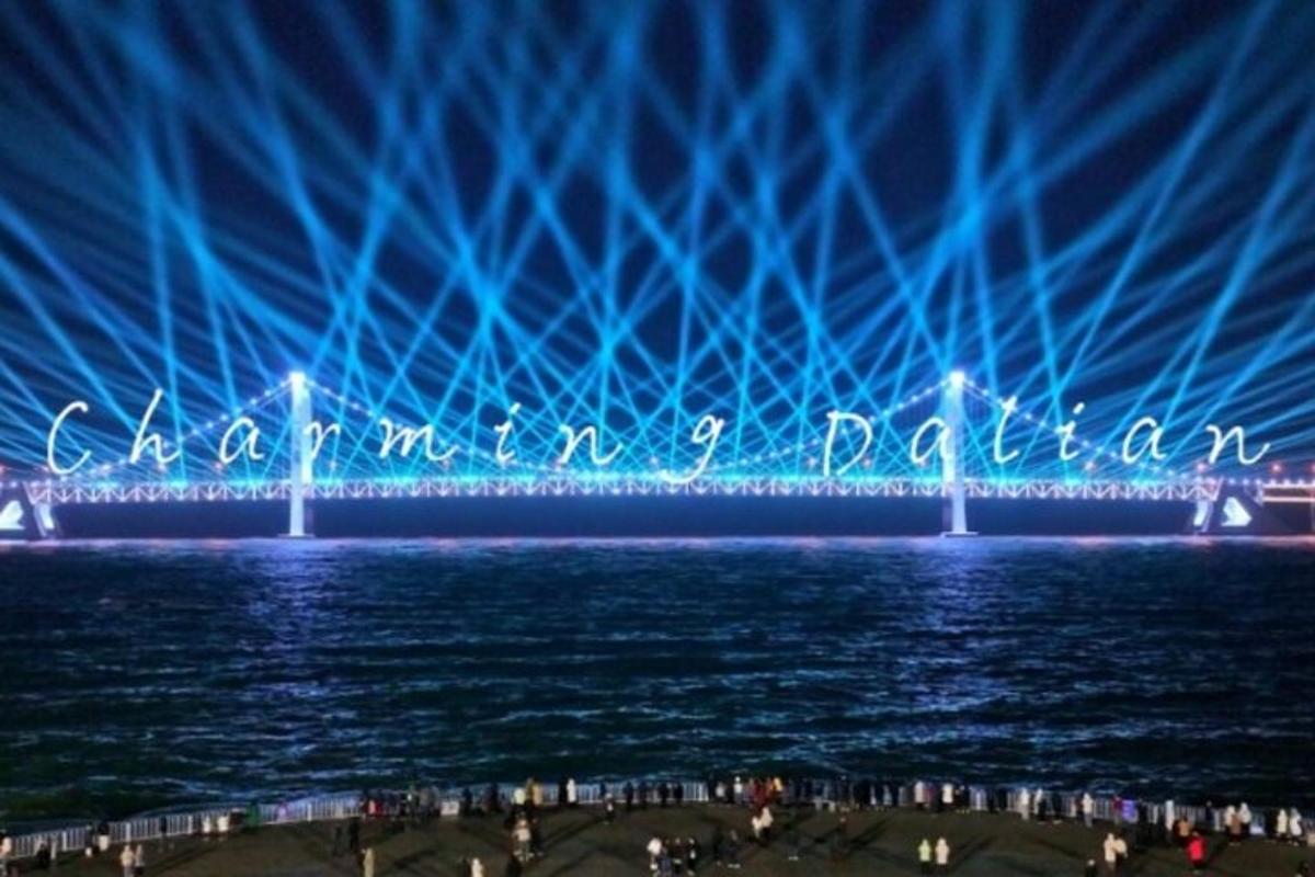 a bridge over the water at night with blue lights