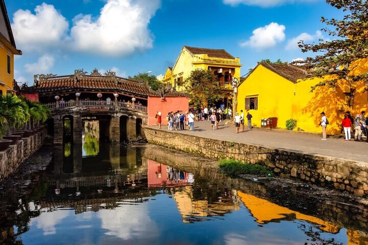 a group of people walking on a sidewalk next to a river