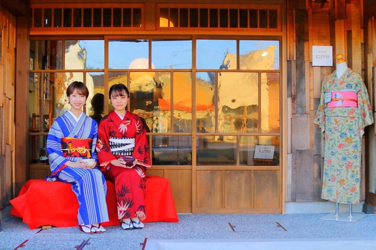 two women are sitting in front of a store
