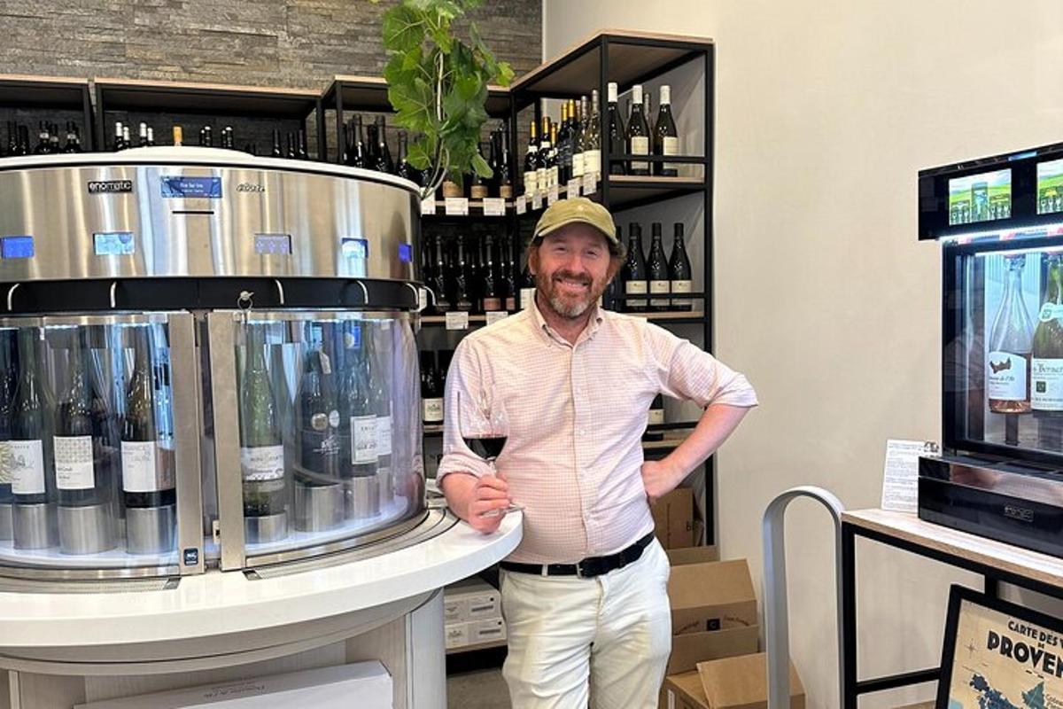 a man is standing next to a wine cooler