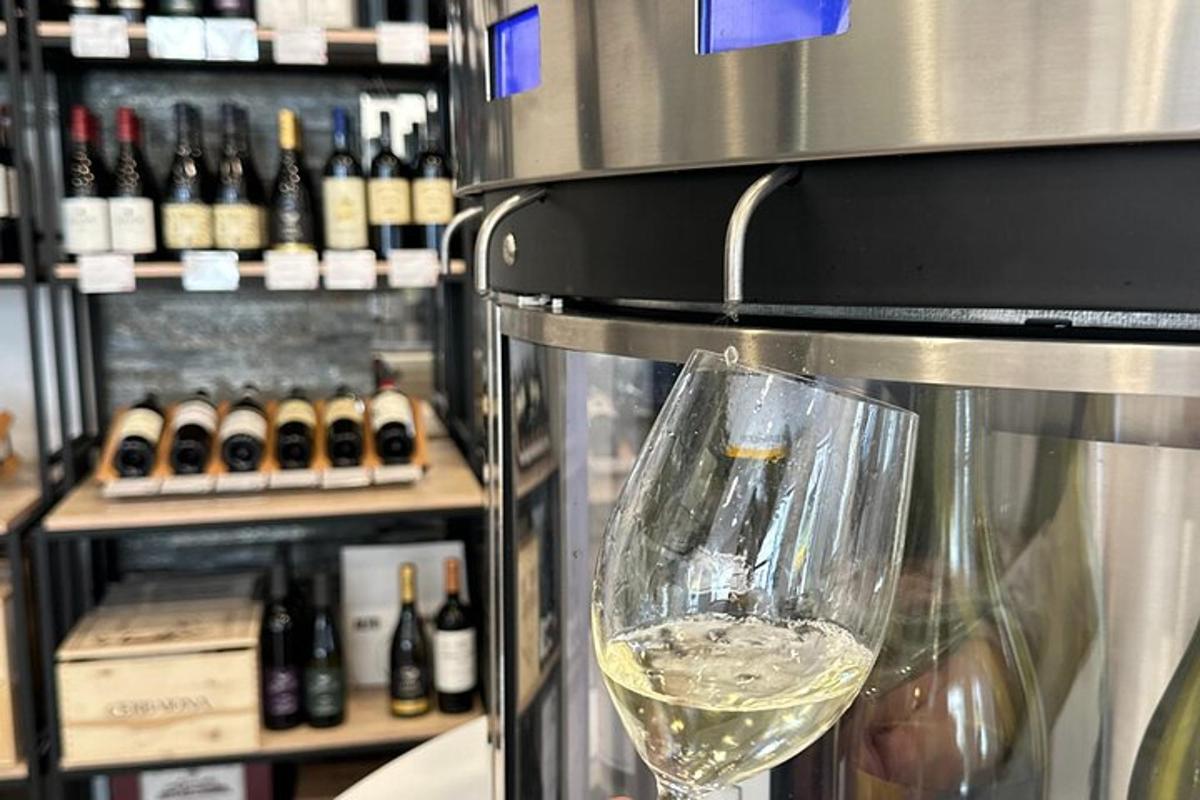 a glass of white wine is in a wine machine