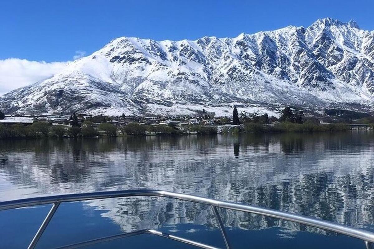 a boat on a lake with a snow covered mountain